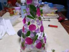 用液体胶把不同颜色的花瓣粘到准备的随意玻璃瓶上