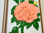 使用粉色+橙色调成橙红色的花朵花瓣，和青色+绿色调成的叶子，再绘制一副画捏制成的。